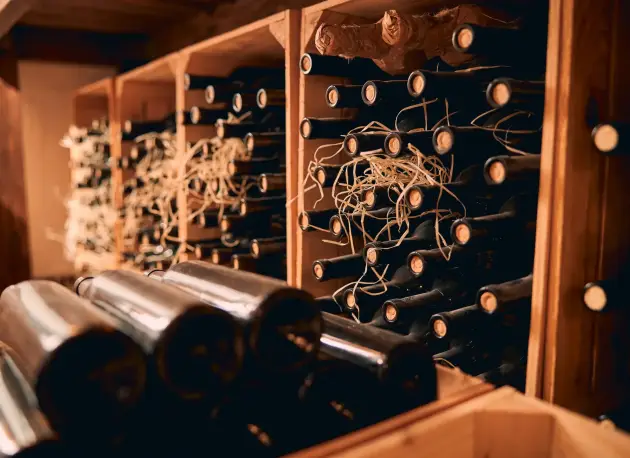 wooden-racks-with-wine-bottles-in-storage-room-2023-11-27-05-24-07-utc wooden-racks-with-wine-bottles-in-storage-room-2023-11-27-05-24-07-utc
